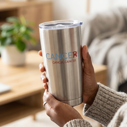Person holding a stainless steel tumbler with Cancel Cancer logo.